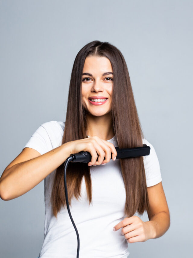 portrait-cheerful-woman-using-straightener-her-curly-hair-preparing-event-date-holiday-comfortable-easy-hairdo-isolated-grey